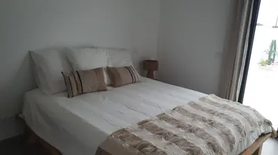 a large white bed with two pillows on it at villa blue mango in Sagres