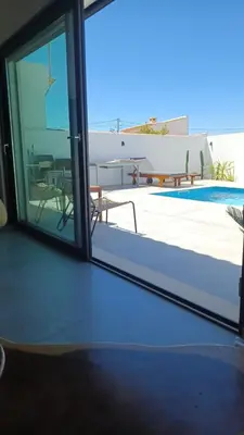 a room with a white building with a black door at villa blue mango in Sagres