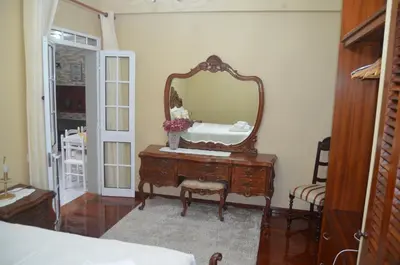 a bedroom with a dresser with a mirror on it at Vista dos Encantos in Machico
