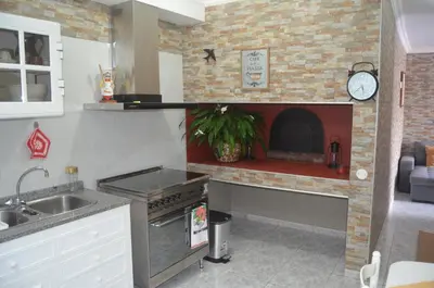 a kitchen with a brick fireplace in a kitchen at Vista dos Encantos in Machico
