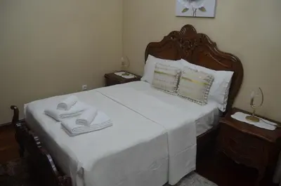 a bedroom with a white bed with towels on it at Vista dos Encantos in Machico