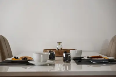 a table with two plates of food on it at Urban Stay 1B by Homie in Funchal