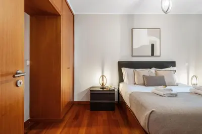 a bedroom with a large bed with a wooden floor at Urban Stay 1B by Homie in Funchal
