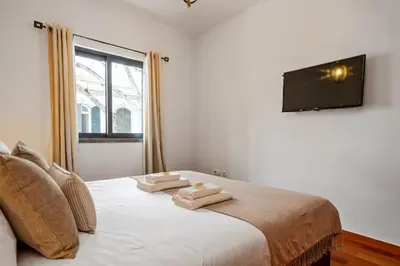 a bedroom with a bed with two towels on it at Urban Stay 1B by Homie in Funchal
