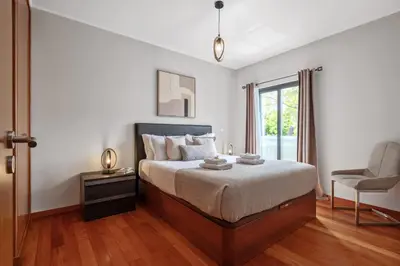 a bedroom with a bed and a chair and a window at Urban Stay 1B by Homie in Funchal