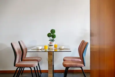 a table with two chairs and a plant on it at Urban Stay 1A by Homie in Funchal