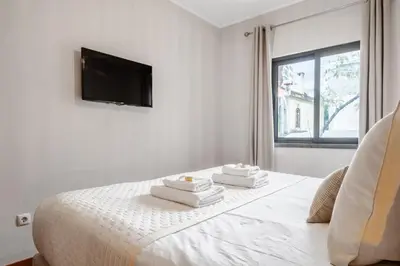 a white bedroom with a bed with towels on it at Urban Stay 1A by Homie in Funchal