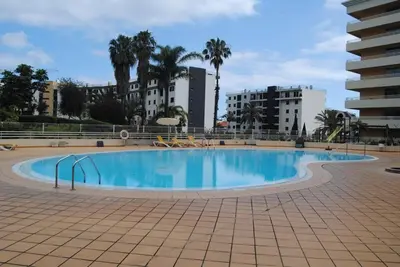 a large swimming pool in the middle of a building at Aurora Park com piscina in Funchal