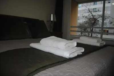 a pile of towels sitting on top of a bed at Aurora Park com piscina in Funchal