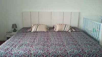 a bed with two pillows and a crib in a bedroom at Vista Funchal in Funchal