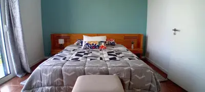 a bedroom with a bed and a chair at Vista Funchal in Funchal