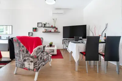 a dining room with a table and chairs and a desk at Casa Annie in Arco da Calheta