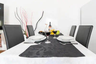 a dining room table with a black and white table cloth at Casa Annie in Arco da Calheta