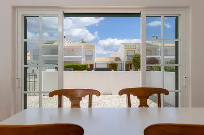 a table with two chairs in front of a window at Spacious Villa - Walk to Beach & City Center in Lagos