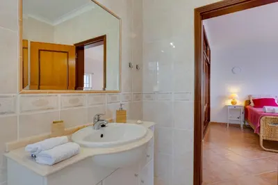 a bathroom with a sink and a mirror at Spacious Villa - Walk to Beach & City Center in Lagos