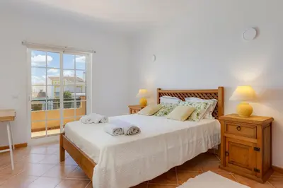 a bedroom with a large bed and a window at Spacious Villa - Walk to Beach & City Center in Lagos