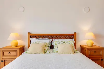 a bedroom with a bed with two lamps on night stands at Spacious Villa - Walk to Beach & City Center in Lagos