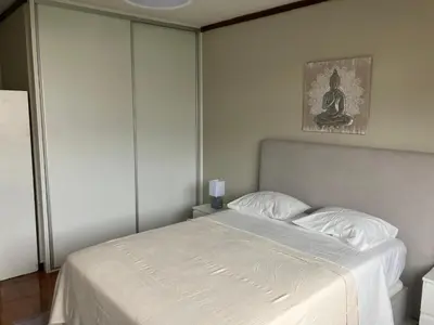 a bedroom with a bed with a white bedspread at Vista Montanha Funchal in Funchal