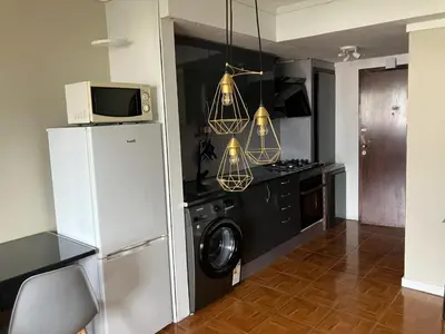 a kitchen with a refrigerator and a microwave at Vista Montanha Funchal in Funchal