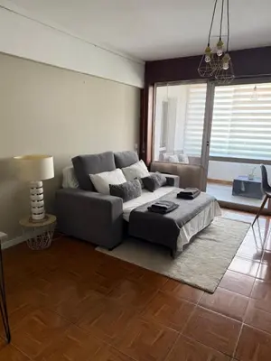a living room with a couch and a table at Vista Montanha Funchal in Funchal