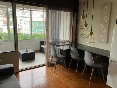 a kitchen with a table and chairs in a room at Vista Montanha Funchal in Funchal