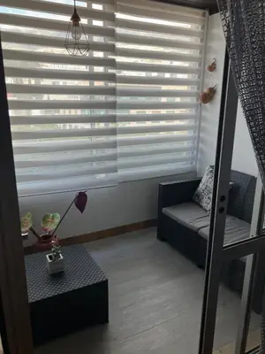 a living room with a large window with blinds at Vista Montanha Funchal in Funchal