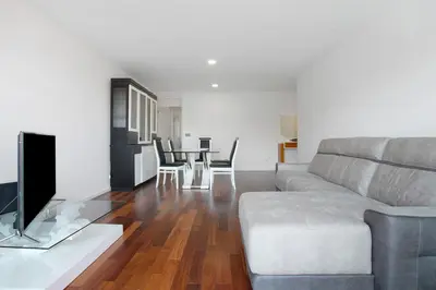 a living room with a couch and a table with chairs at Macedo Penthouse in Funchal