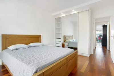 a bedroom with a large bed and a mirror at Macedo Penthouse in Funchal