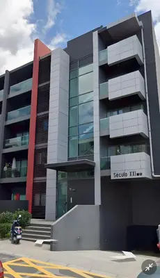 a building with a scooter parked in front of it at Macedo Penthouse in Funchal