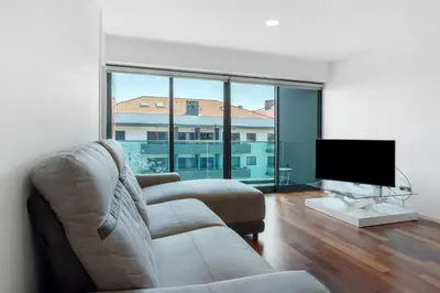 a living room with a couch and a flat screen tv at Macedo Penthouse in Funchal