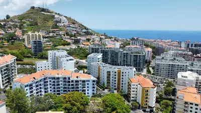 an aerial view of a city with a hill at Madeira Residence in Funchal