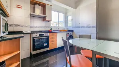 a kitchen with a table and a counter top at Madeira Residence in Funchal