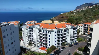 an aerial view of a building near the ocean at Madeira Residence in Funchal