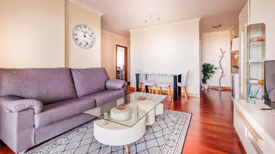 a living room with a purple couch and a table at Madeira Residence in Funchal