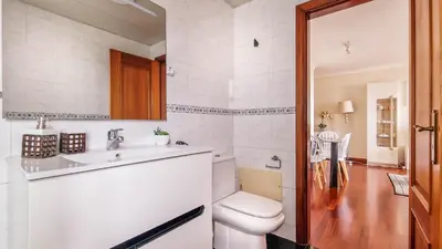 a bathroom with a toilet and a sink at Madeira Residence in Funchal