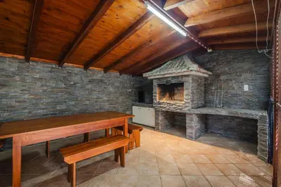 a kitchen with wooden cabinets and a stove top oven at Santo Refúgio in Porto Santo