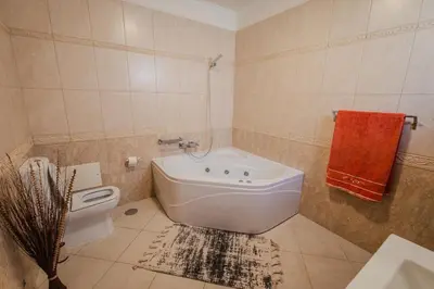 a bedroom with a bed and a dresser and a mirror at Santo Refúgio in Porto Santo