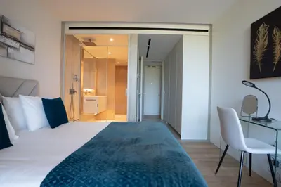 a bedroom with a bed and a desk and a chair at Cloud9 by LovelyStay in Funchal