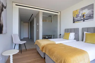 a hotel room with two beds and a table at Cloud9 by LovelyStay in Funchal