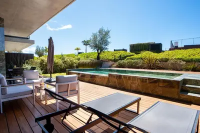 a patio with chairs and a swimming pool at Cloud9 by LovelyStay in Funchal