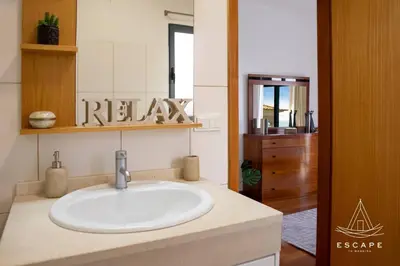 a bedroom with a bed with a view of the ocean at Villa Izilda by ESCAPE to Madeira in Ponta do Sol