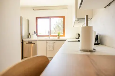 a kitchen with a counter top and a window at Green House Beach Side Oasis in Vila Baleira