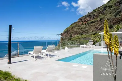 a villa with a pool and a view of the ocean at Villa Nicuma by ESCAPE to Madeira in Calheta