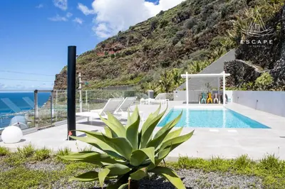 a villa with a swimming pool and a mountain at Villa Nicuma by ESCAPE to Madeira in Calheta