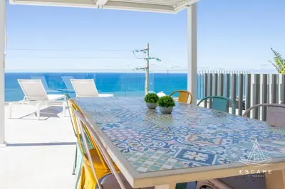 a table with plants on top of a patio at Villa Nicuma by ESCAPE to Madeira in Calheta