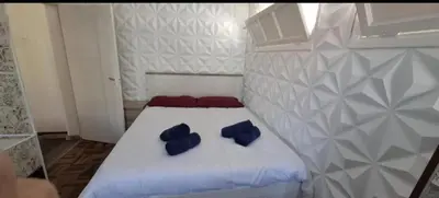 a bed with two blue pillows on top of it at Great Stay 1 Bedroom Funchal Central Duplex Retreat in Funchal