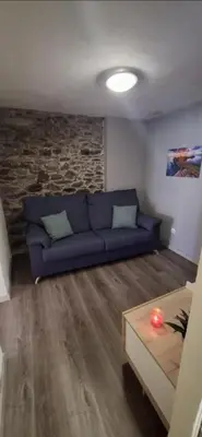 a living room with a blue couch and a table at Great Stay 1 Bedroom Funchal Central Duplex Retreat in Funchal