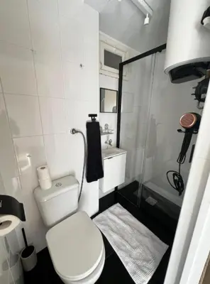 a small bathroom with a toilet and a shower at Great Stay 1 Bedroom Funchal Central Duplex Retreat in Funchal