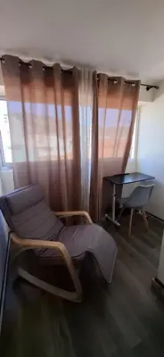 a chair and a table in a room with a window at Great Stay 1 Bedroom Funchal Central Duplex Retreat in Funchal