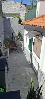 an alley with a building and a table and some plants at Great Stay 1 Bedroom Funchal Central Duplex Retreat in Funchal